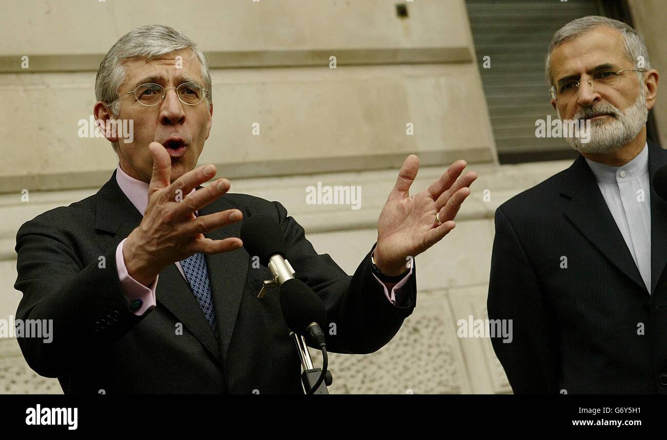 Britain's Foreign Minister Jack Straw listens to his Iranian counterpart Kamal Kharrazi speaks outside the Foreign Office in London Mr Straw and Britain's Prime Minister Tony Blair earlier held talks with Mr Kharrazi about Iran's nuclear programmes. Stock Photo