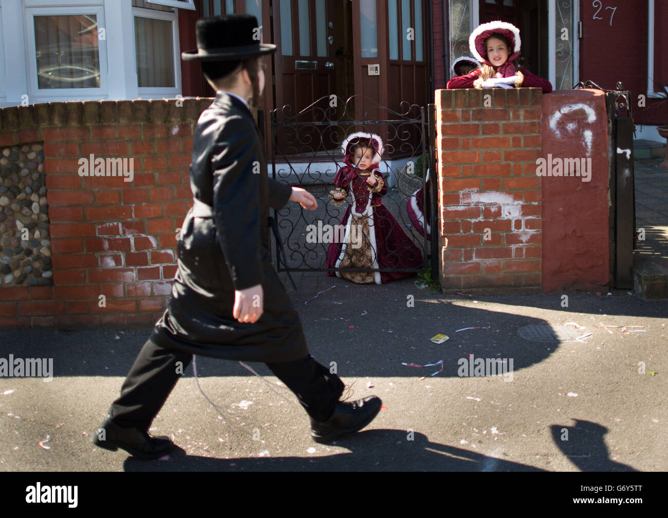 Orthodox Jewish children celebrate the festival of Purim in the streets of Stamford Hill in north London. The holiday that commemorates the deliverance of the Jewish people in the ancient Persian Empire from destruction in the wake of a plot by Haman, a story recorded in the Biblical Book of Esther is marked by parties in which children wear fancy dress costumes and take gifts to neighbouring friends and family. Stock Photo