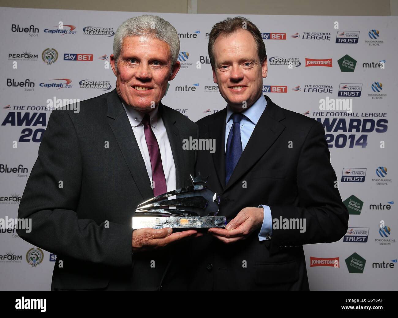 Southend United's Frank Banks (left) recieves the Tokio Marine Unsung Hero award from Tokio Marine's Executive Operations Officer Alastair Blundell at the Football League Awards 2014 Stock Photo