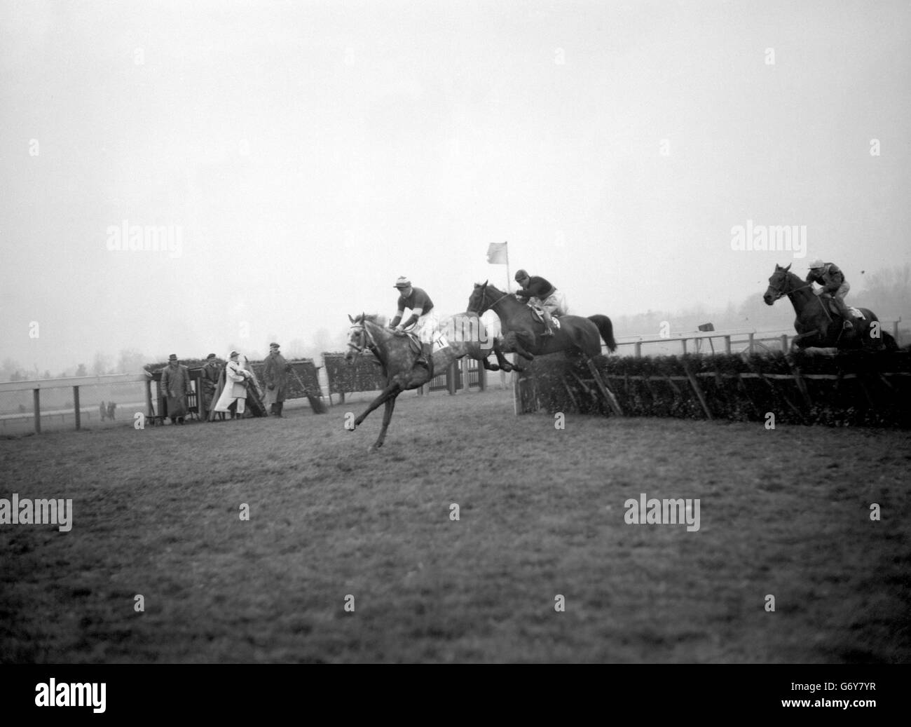 Leading as the last hurdle is cleared, Branca Doria, ridden by R. J. Hamey, was the winner of the Annual Handicap Hurdle race at Sandown Park. Second was Sago (seen in second position), ridden by F Winter, and third was St Kilda, ridden by D Weeden. Stock Photo