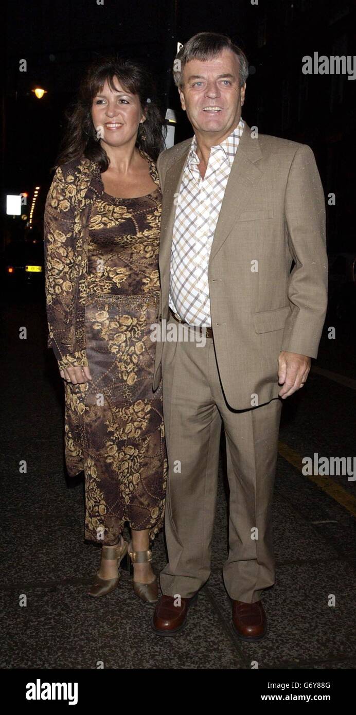 Radio DJ Tony Blackburn and his wife arrive for Granada TV's 'I'm A Celebrity...Get Me Out Of Here!' third anniversary party at the Delfina Gallery in south London to celebrate the success of the Australian jungle reality TV show. Stock Photo