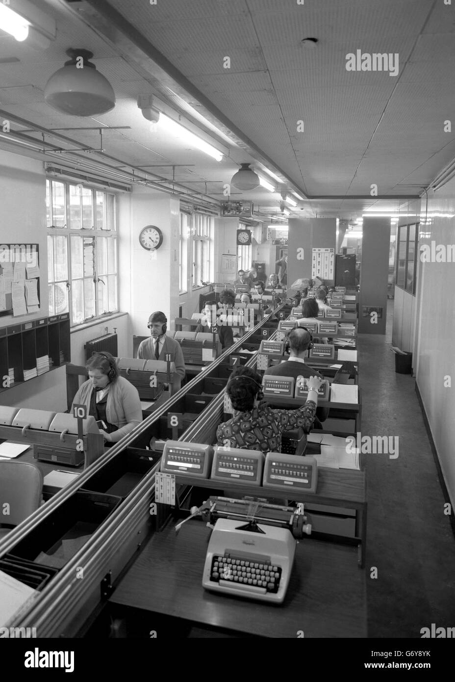 News cascades into the Press Association's headquarters in Fleet Street from an army of staff reporters and 1500 correspondents throughout the British isles. An automaticc telephone exchange links reporters to copy-takers. It is on a 'battery' such as this that the General Election results and stories will be received on March 31st and April 1st. Within seconds the facts and figures will be transmitted to newspapers throughout the country and fed into a NCR 315 computer for split second calculation. Stock Photo