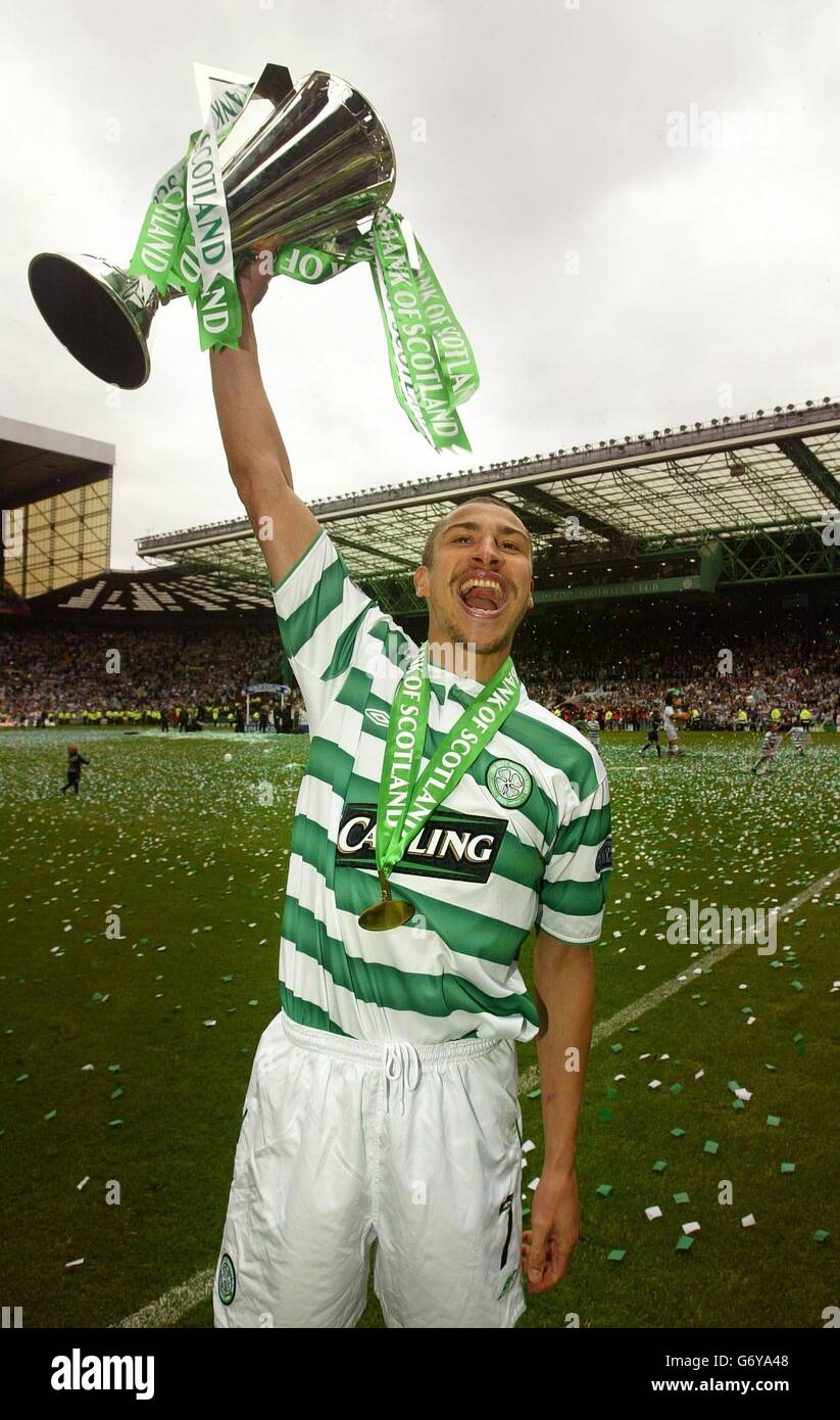 Celtic's Swedish striker Henrik Larsson celebrates after being presented with the Bank of Scotland Premier League trophy at Celtic park, Glasgow. ** Stock Photo