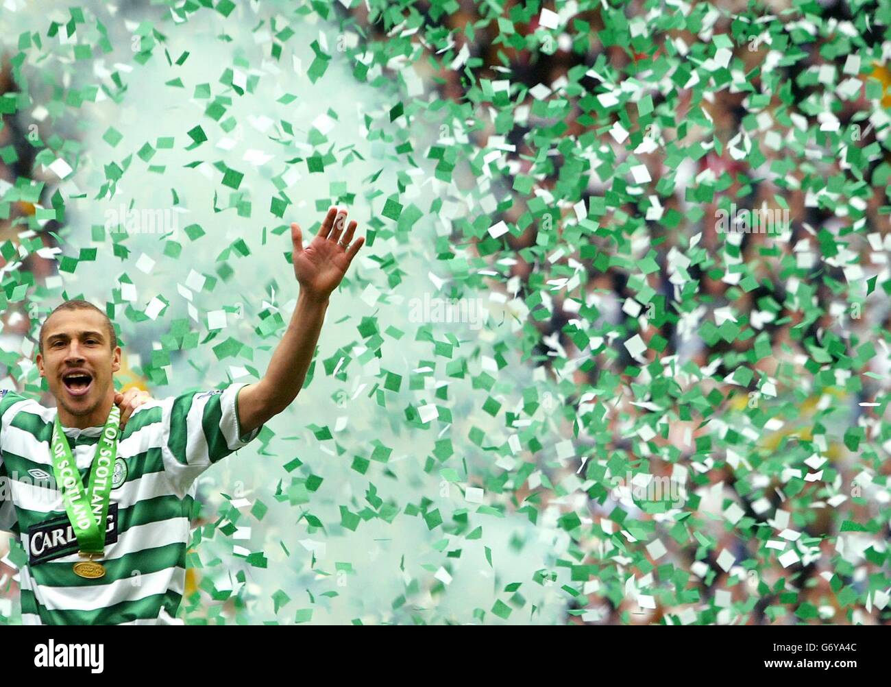 Celtic's Swedish striker Henrik Larsson celebrates after being presented with the Bank of Scotland Premier League trophy at Celtic park, Glasgow. *EDITORIAL USE ONLY* Stock Photo