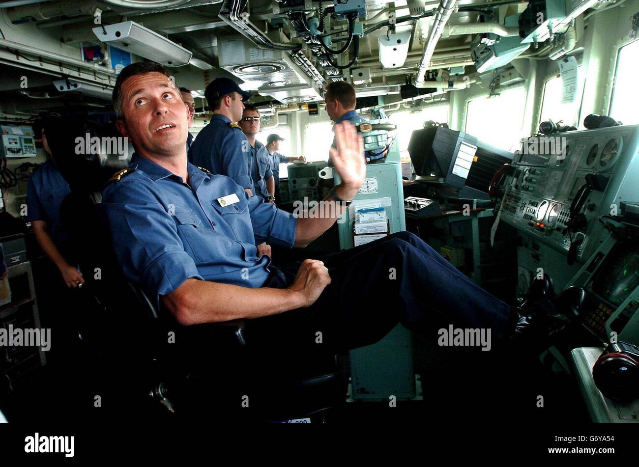 Commander Adrian Cassar looks over the side of the navy frigate HMS Grafton as it leaves port in Dubai, to begin patrolling off the coast of Iraq Stock Photo