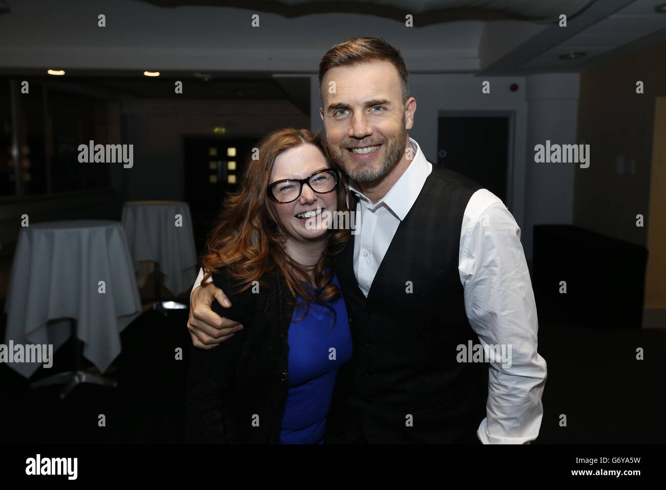 Gary Barlow poses with fan before performing an intimate gig at Under the Bridge, Stamford Bridge, London for Heart FM listeners and sponsored by Boots. Stock Photo