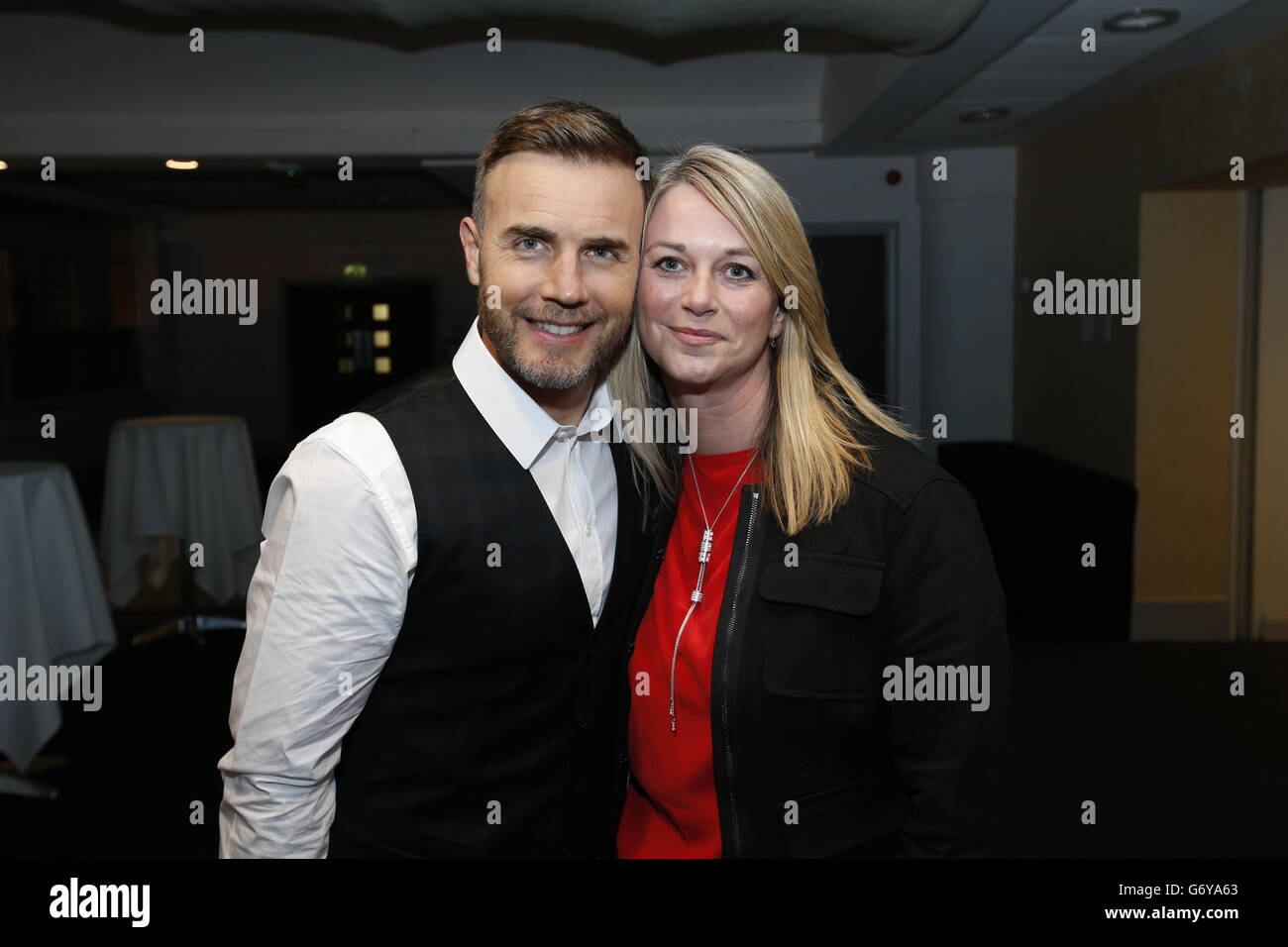 Gary Barlow poses with fan before performing an intimate gig at Under the Bridge, Stamford Bridge, London for Heart FM listeners and sponsored by Boots. Stock Photo