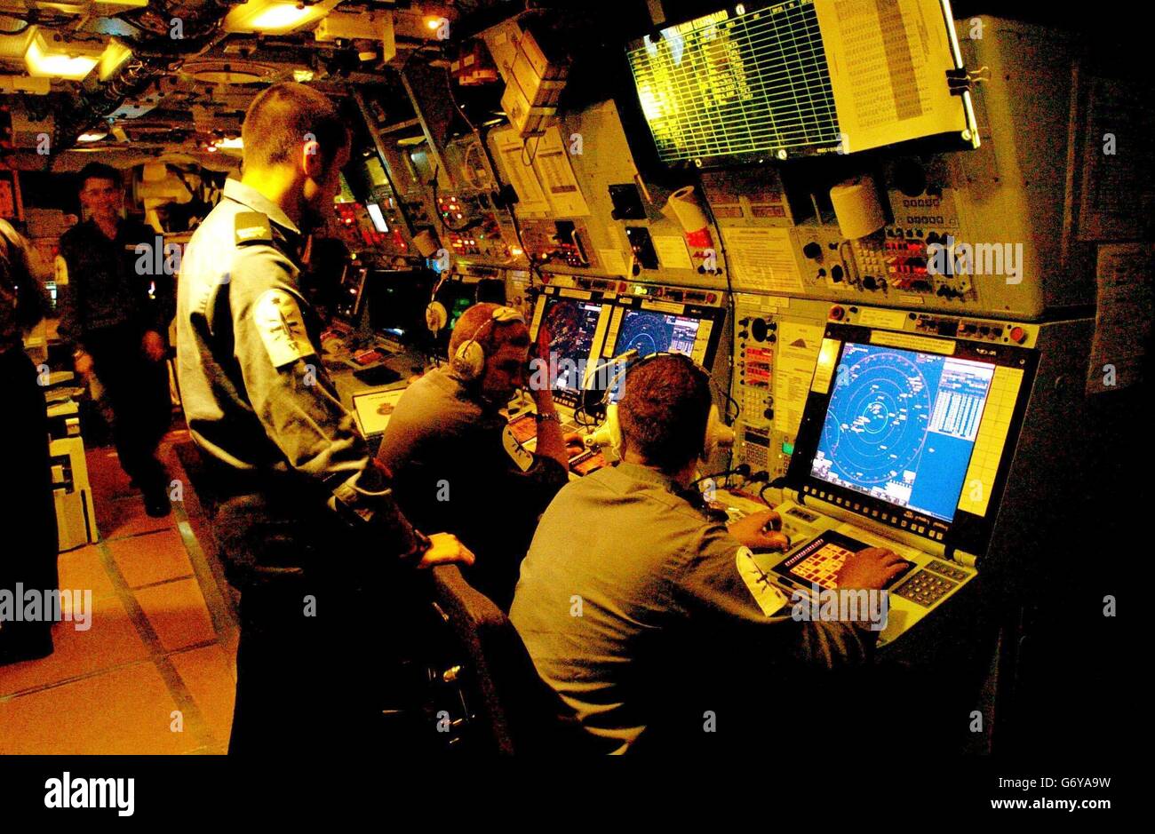 Crew members study radar instruments in the HMS Grafton's Operations Room. The Portsmouth-based Type 23 Frigate is currently patrolling the waters off the coast of Iraq. Stock Photo