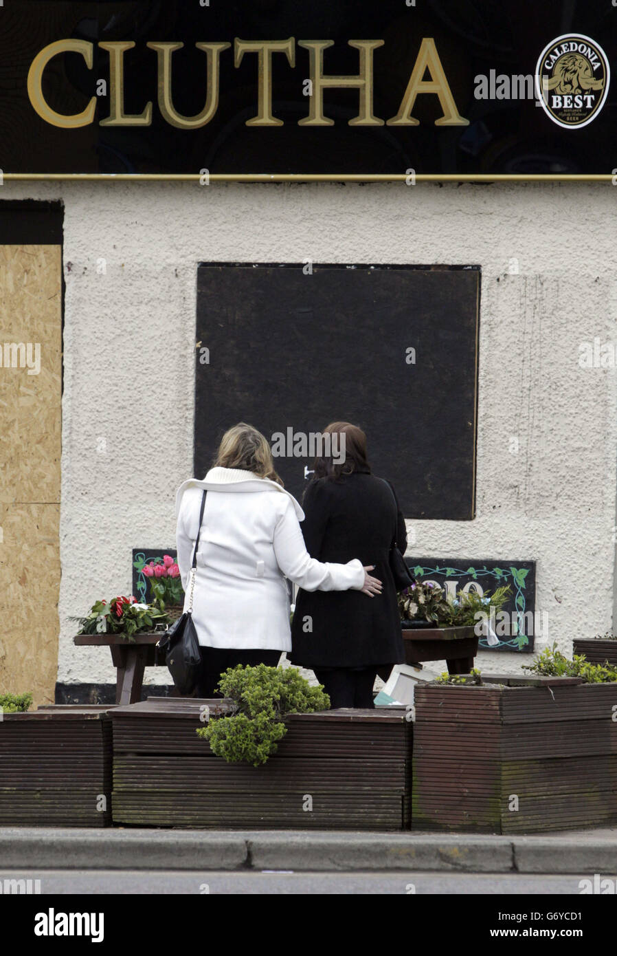 Flowers are laid at the Clutha bar in Glasgow, Scotland, four months after 10 people died following a helicopter accident. Stock Photo