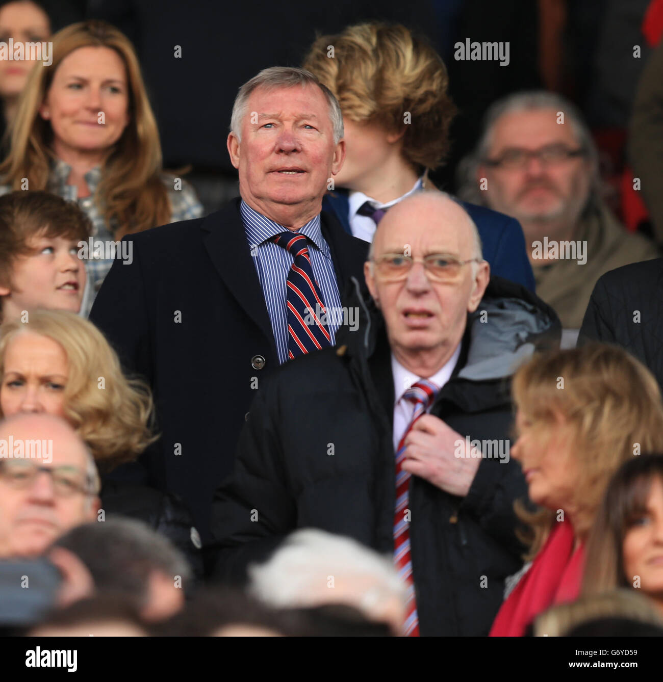 Former Manchester United manager Sir Alex Ferguson takes his seat in the  stands behind David Moyes' father David Moyes Snr Stock Photo - Alamy