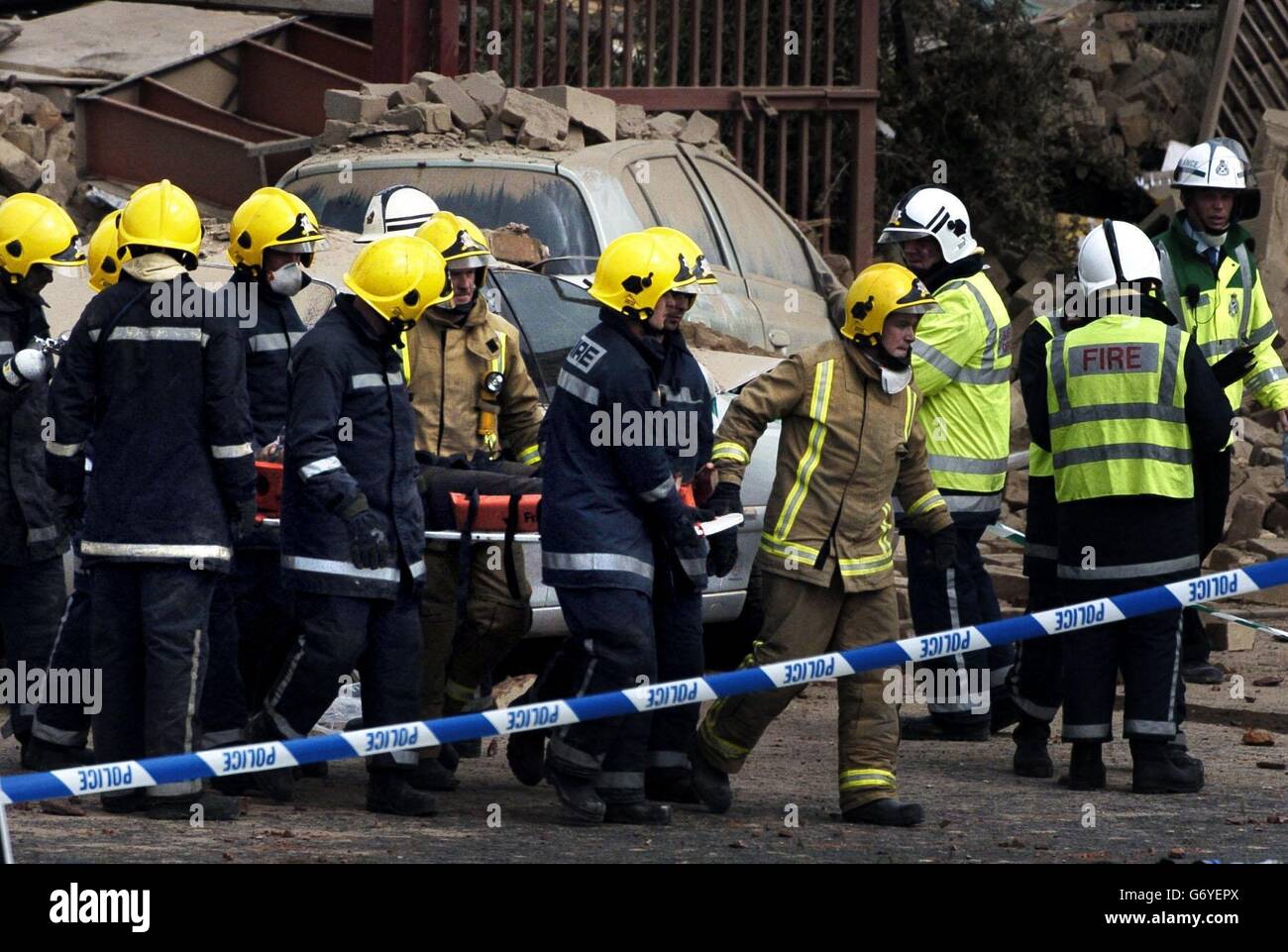 Emergency services remove a body on a stretcher from a plastics factory