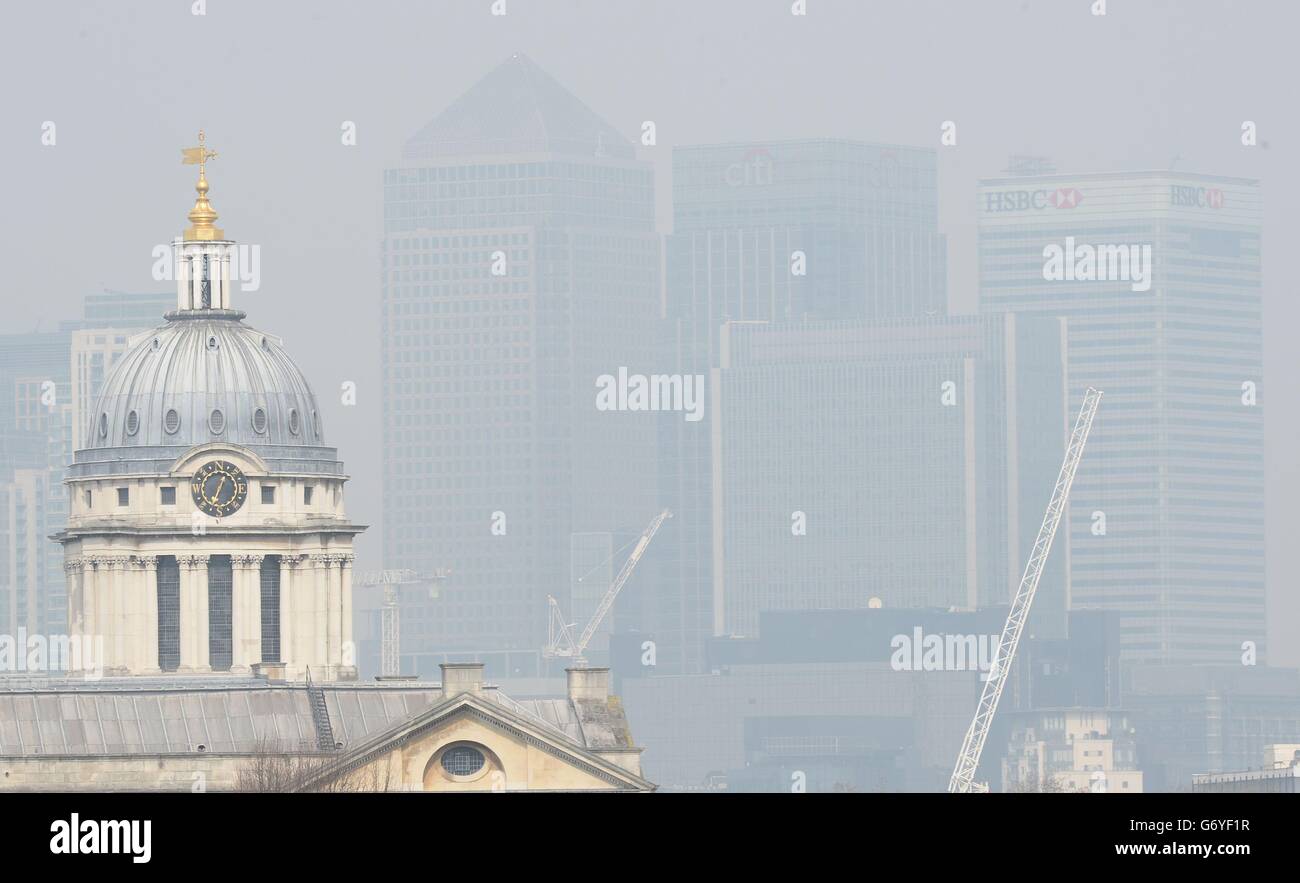 Dust particles and pollution from cars hangs over London, seen from Greenwich, as people suffering the effects of high levels of pollution - including sore eyes, coughs and sore throats - should cut down the amount of activity they take outside, experts have warned. Stock Photo