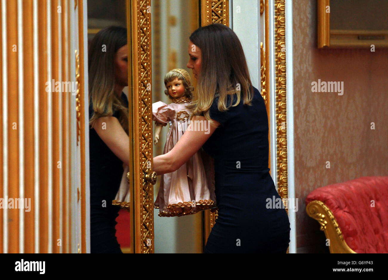 Curator Anna Reynolds with one of the Parisian dolls that belonged to Princess Margaret at the launch of the summer exhibition Royal Childhood at Buckingham Palace, London, which celebrates royal childhood with toys and family gifts belonging to the royal children when they were growing up. Stock Photo