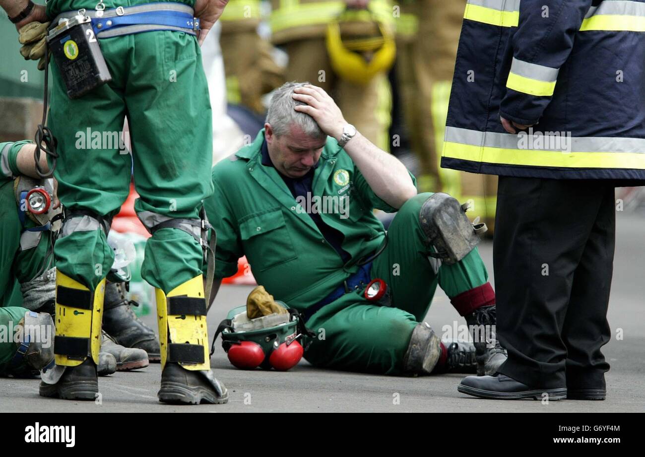 Rescue workers take a break during the long process of searching the