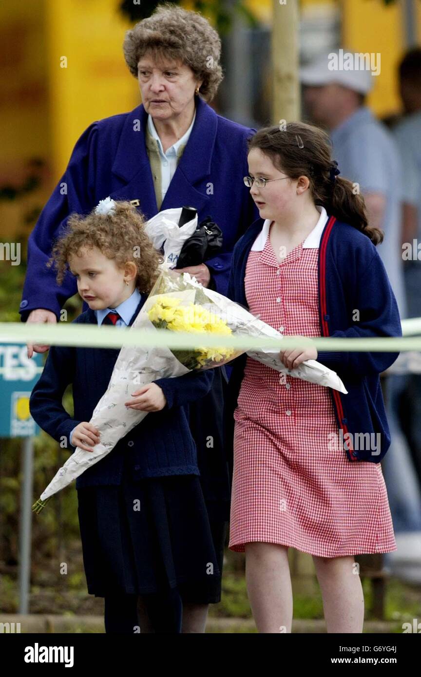 Children lay flowers at the Stockline Plastics factory in Glasgow