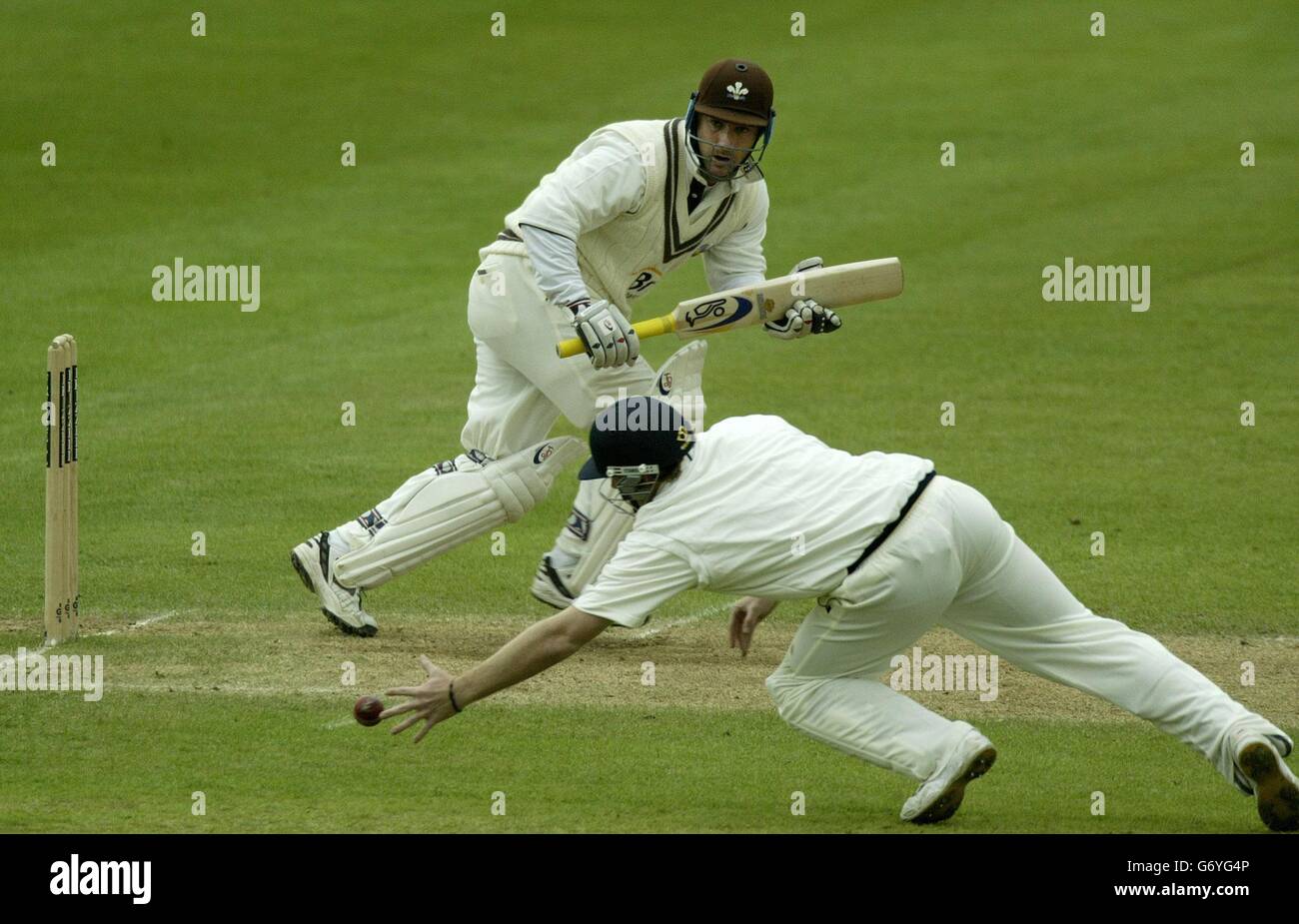 Surrey's Graham Thorpe trys to steer the ball past Warwickshire fielder Ian Bell, on the second day of Frizzell County Championship Division One match at Edgbaston, Birmingham. Stock Photo