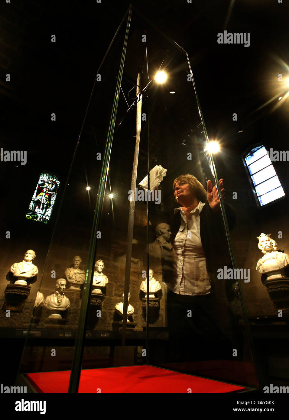 Janice Black polishes the cabinet housing the Wallace Sword - purported to to have belonged to William Wallace - after it was reinstalled in its home at The National Wallace Monument in Stirling. Stock Photo