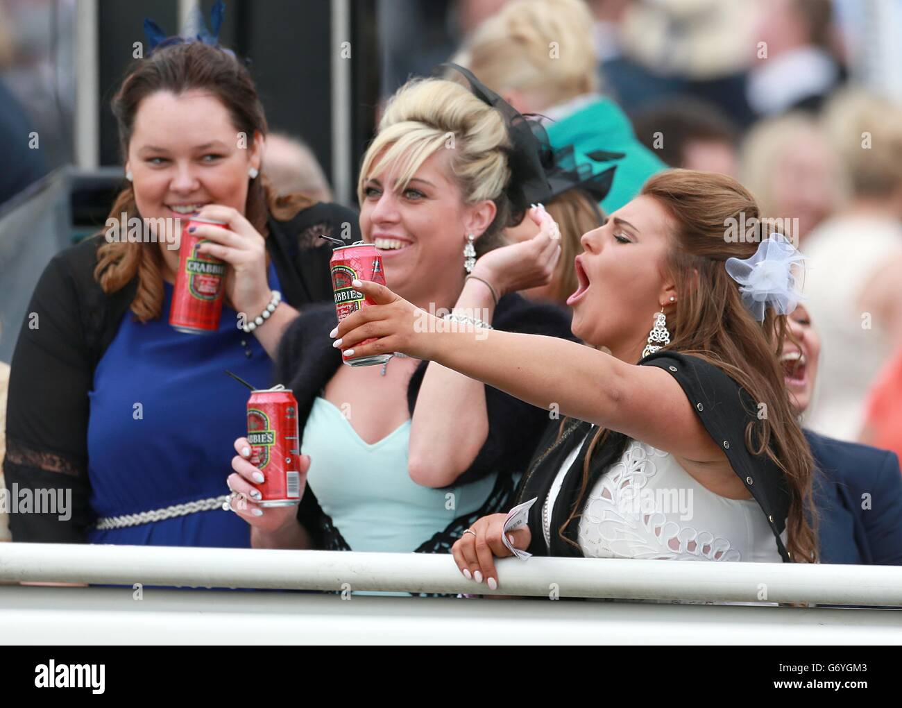 Horse Racing - The Crabbie's Grand National 2014 - Ladies Day - Aintree Racecourse. Animated racegoers on Ladies Day Stock Photo