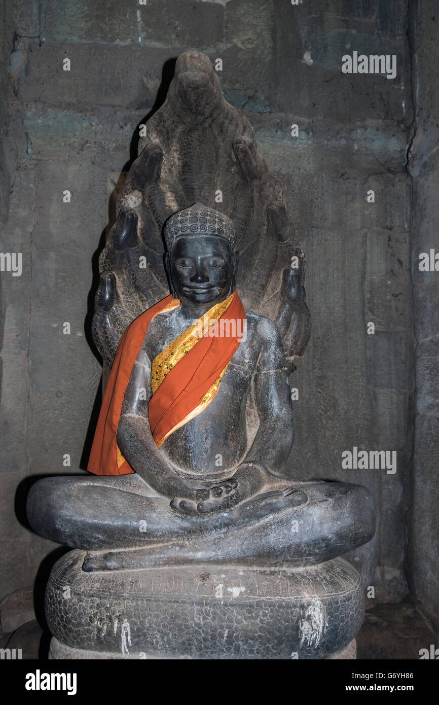 Statue of smiling Buddha in lotus position, Prasat Bayon, Angkor Thom, Cambodia Stock Photo
