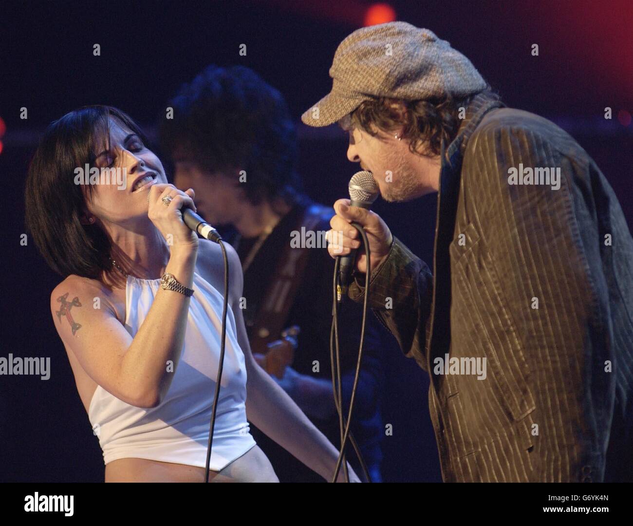 Lead singer Dolores O'Riordan from the The Cranberries joins Italian singer Zucchero onstage during a benefit show in aid of the United Nations UNHCR refugees fund held at the Royal Albert hall, central London. Stock Photo