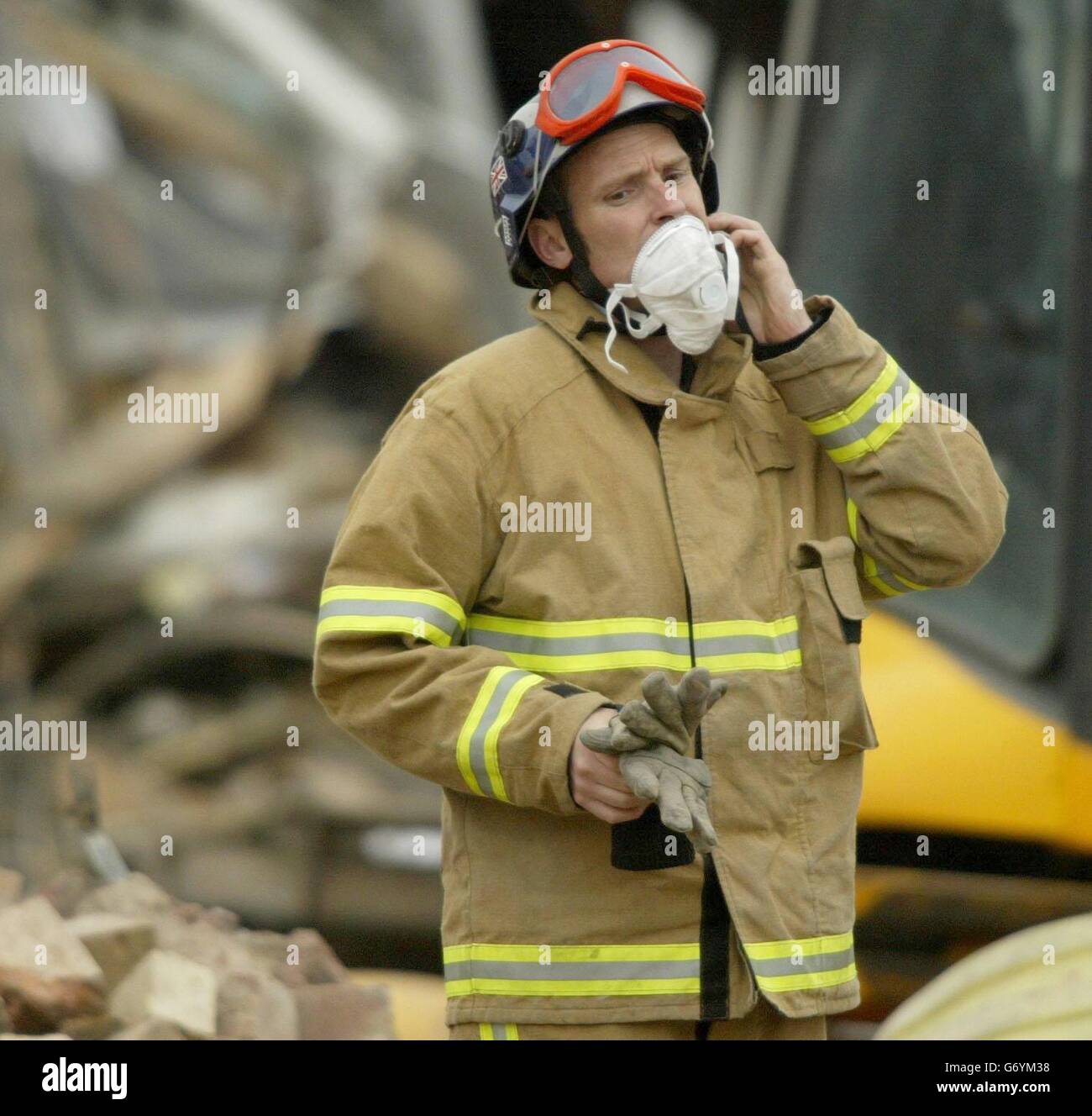 A fireman emerges from the debris at the Stockline Plastics factory in