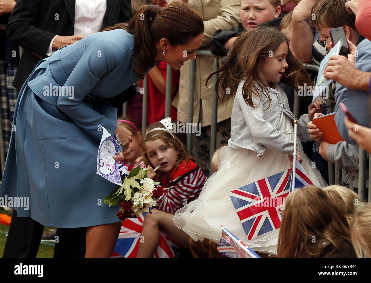 The Duchess of Cambridge, talks with children after laying a wreath at the war memorial in Seymour Square in the town of Blenheim in New Zealand. The royal couple are undertaking a 19-day official visit to New Zealand and Australia with their son George. Stock Photo