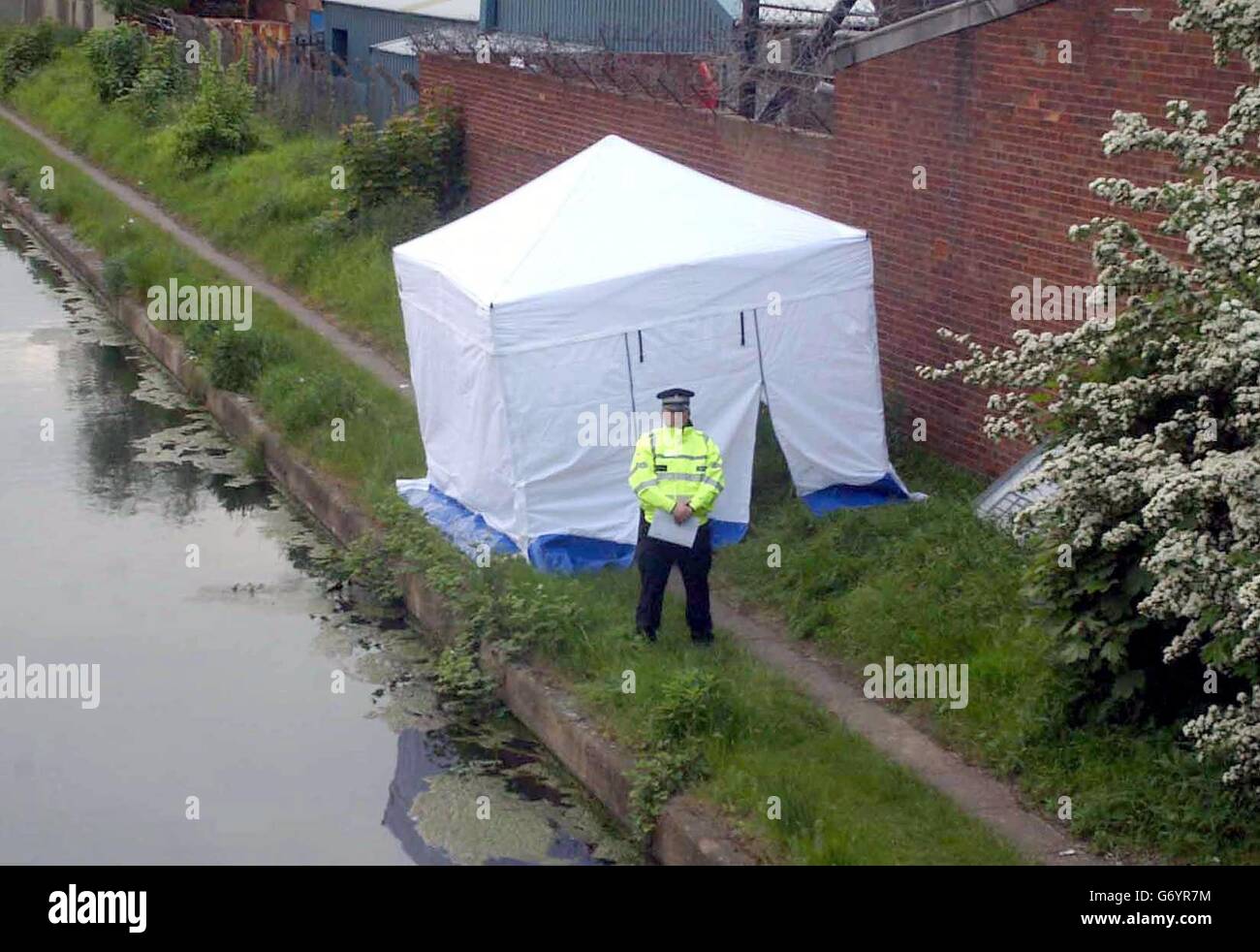 A police officer stands by a tent erected where a West Midlands Police