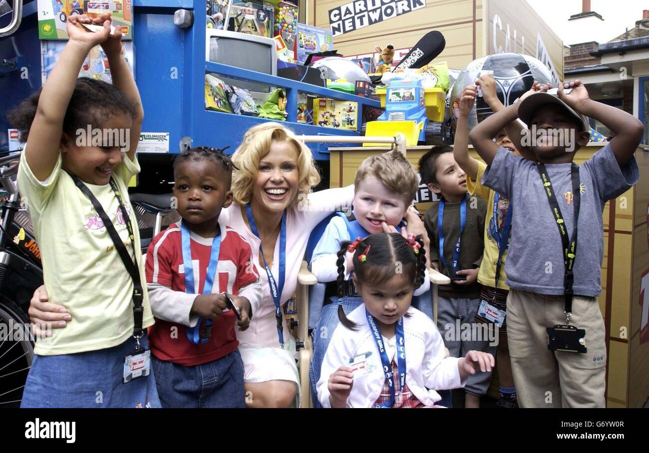 Model and TV presenter Melinda Messenger poses with kids from the Rainbow Children's Centre for photographers during the launch of the Cartoon Network's National TV Game ''TRUCKATOON' at the centre in west London. The game for kids and charities, will see winners getting a truckload of toys delivered to their door, and to a local children's charity. Stock Photo