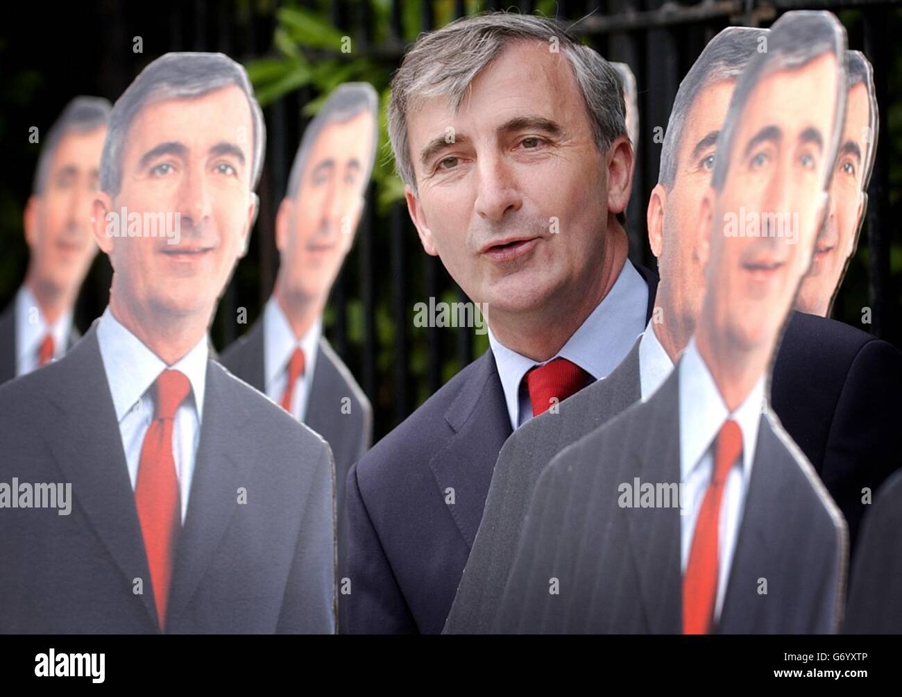 Fine Gael candidate in the forthcoming European elections Gay Mitchell, stands amongst 25 life-size cut outs of himself in Dublin, which will be positioned as part of his campaign at DART Stations, bus stations and canal bridges in the Irish capital in the coming days. Stock Photo