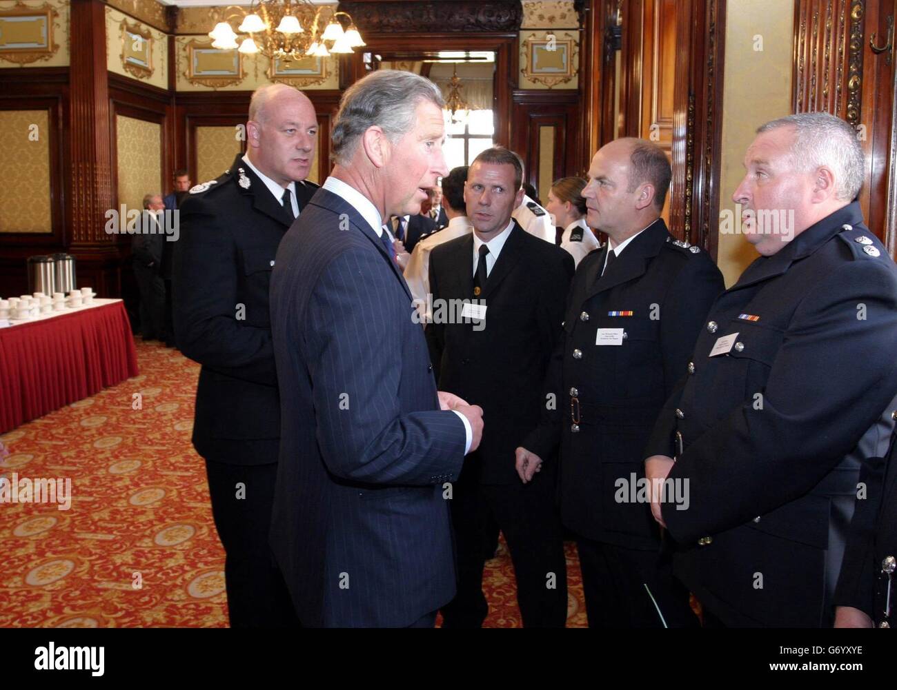 The Prince of Wales is introduced to members of Strathclyde Fire Brigade by Strathclyde Firemaster, Brian Sweeney (left) during a reception where the Prince hailed the 'fantastic' effort of the emergency services involved in the rescue operation after a blast which claimed nine lives at a plastics factory. Charles met workers from the fire, police and ambulance services, as well as volunteers, at Glasgow's City Chambers as part of a three-day visit to Scotland. Stock Photo