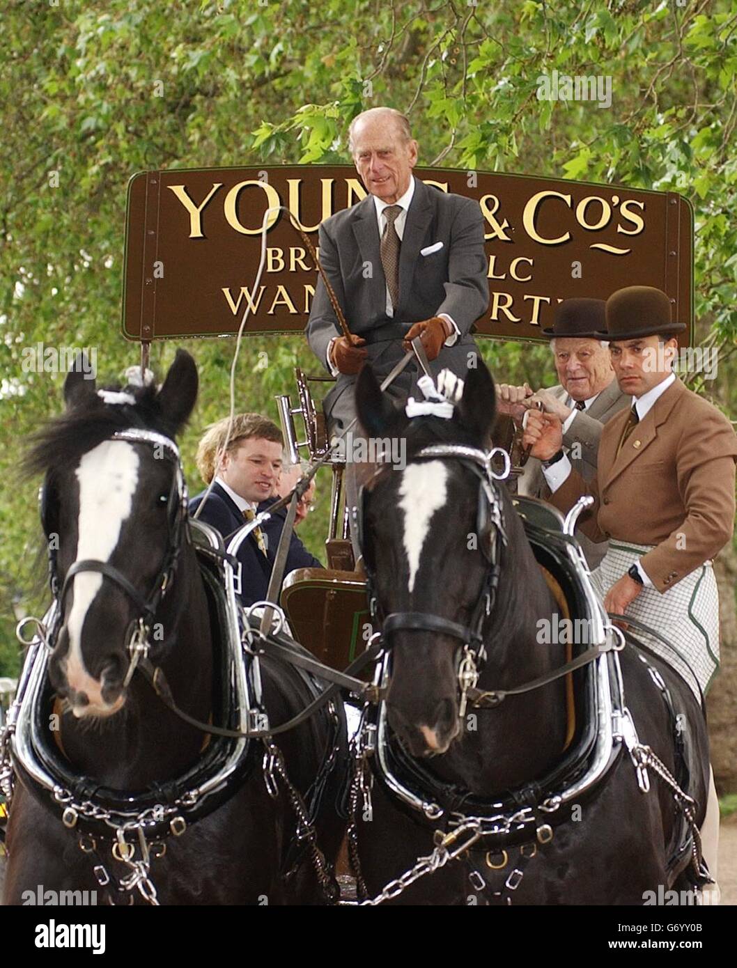 The Duke of Edinburgh takes the reins of two Shire horses as he led