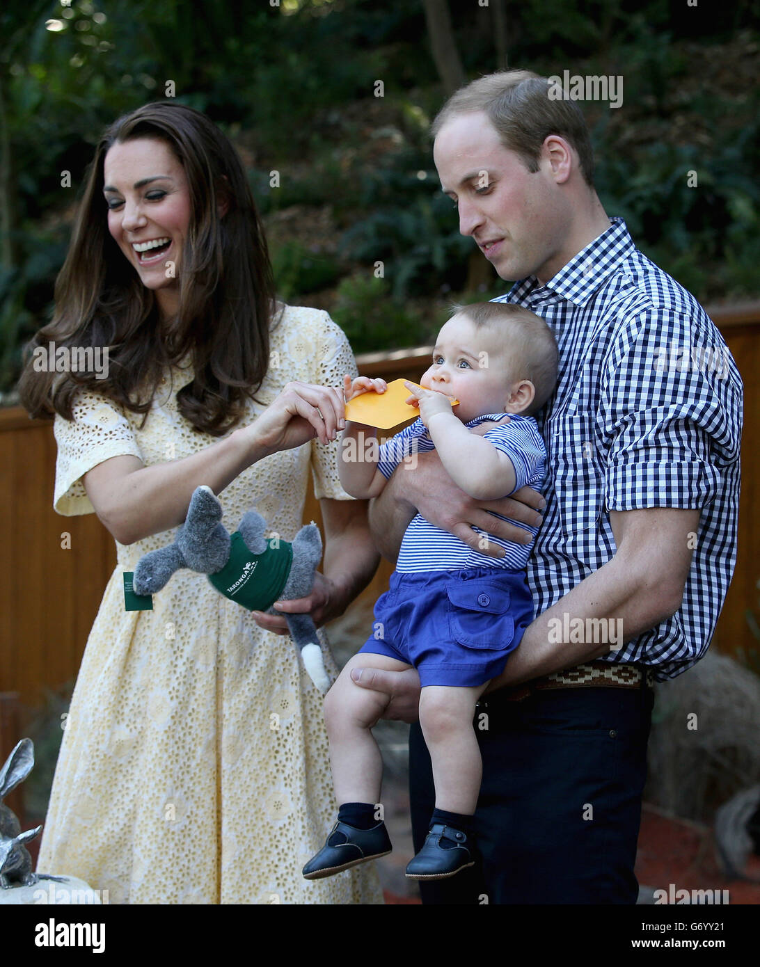 The Duke and Duchess of Cambridge with Prince George of Cambridge as he chews a sticker during a visit to at Taronga Zoo in Sydney, Australia, the Duke and Duchess of Cambridge are on a three-week tour of Australia and New Zealand. Stock Photo