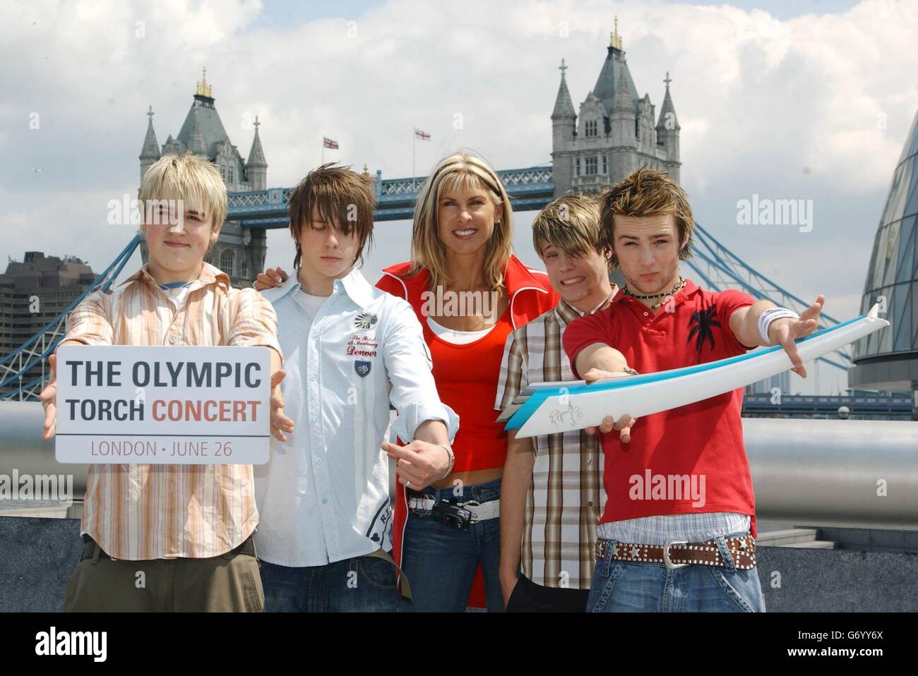 Former Olympic swimmer Sharron Davies and Pop band McFly pose for photographers during a photocall to announce the Olympic Torch Concert at Visit London on London's Southbank. The open-air concert, marking the finish of the 2004 Olympic Torch relay run through London will take place on Saturday 26 June 2004. Stock Photo