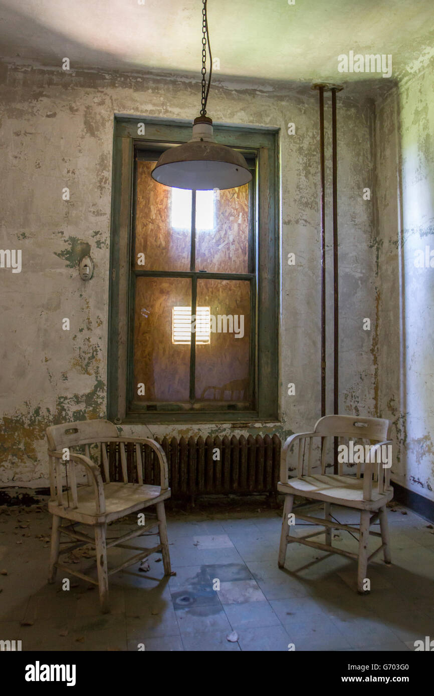 Two chairs sitting in empty room next to window with grunge texture ...