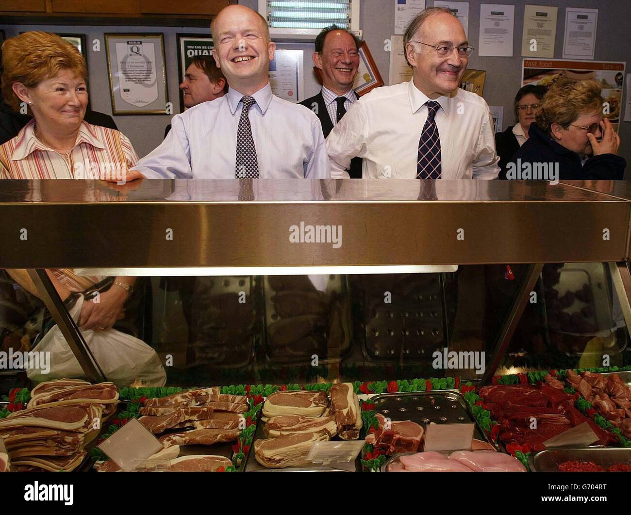 Conservative leader Michael Howard with former Tory leader William Hague (centre left) enter a local butcher shop during a visit to Northallerton, North Yorkshire. Howard earlier launched a blistering attack on the Labour Party and the Liberal Democrats accusing them of leading Britain into the 'straight-jacket' of Europe. Stock Photo