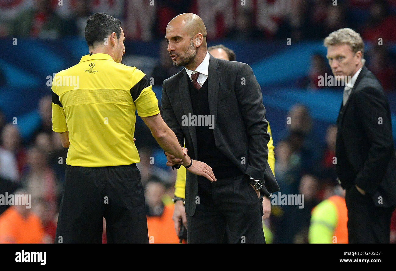 Bayern Munich's Pep Guardiola argues with referee Carlos Velasco Carballo ater he gave a red card to Bayern Munich's Bastian Schweinsteiger, during the UEFA Champions League Quarter Final match Old Trafford, Manchester. Stock Photo
