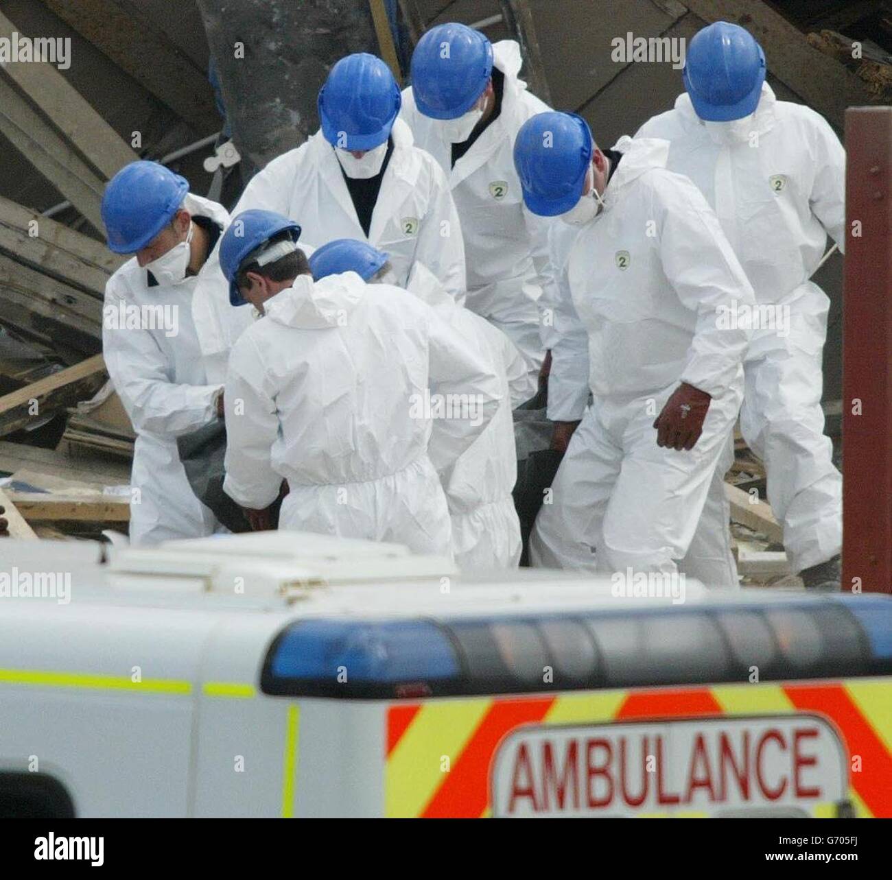 Rescue workers remove a body from the scene at the Stockline Plastics