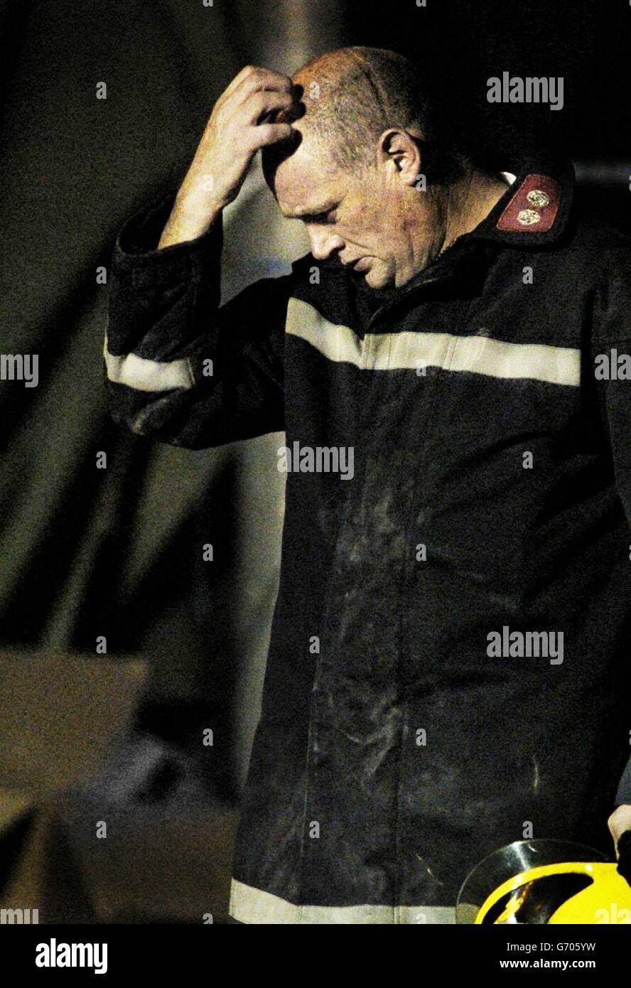 A fireman at the Stockline Plastics factory in Glasgow which collapsed following an explosion Tuesday and where emergency sevice workers have discovered another body. The discovery brought the death toll to eight and it is believed that one man may still be trapped beneath the rubble. Stock Photo