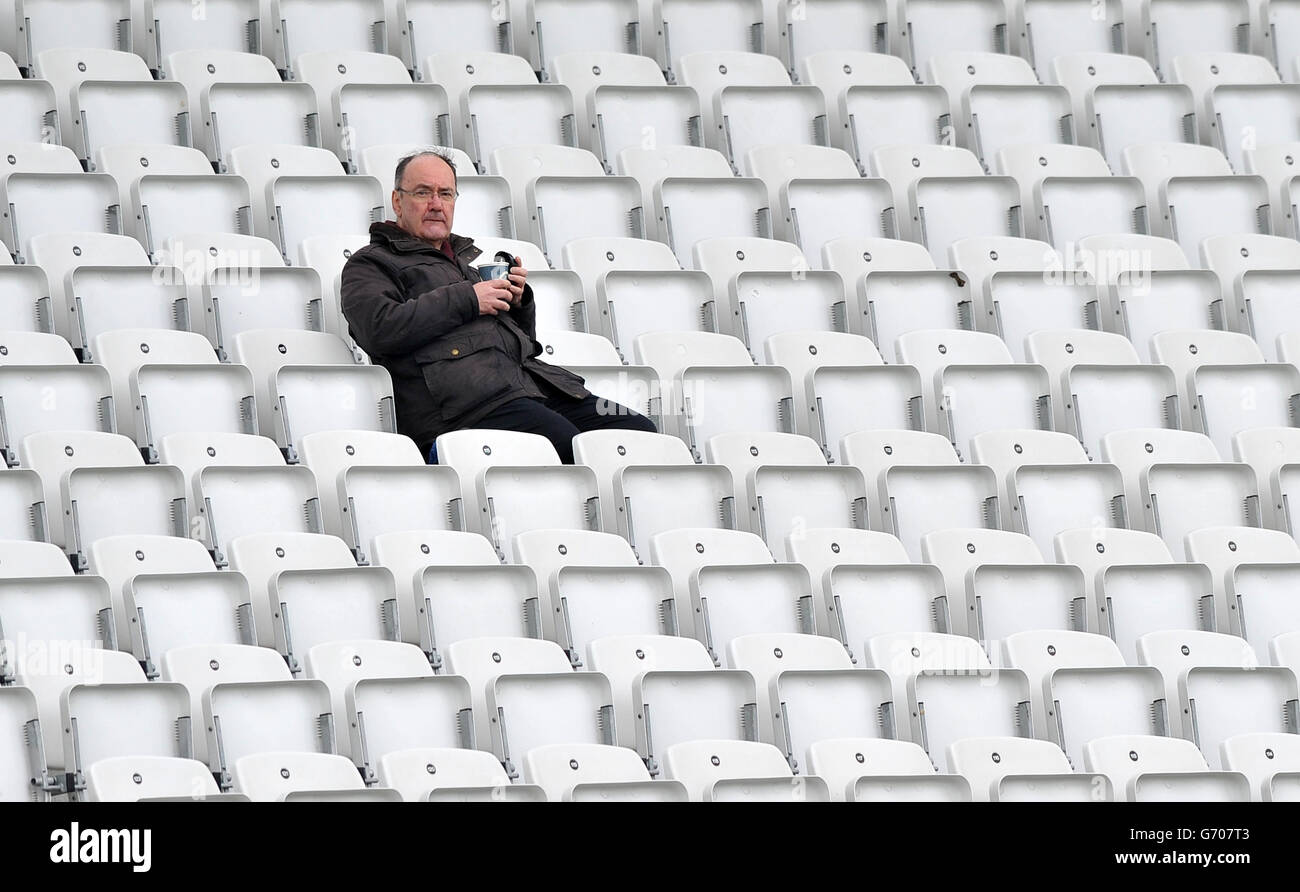A lone fan shelters at the back of the stands as rain delays the start of play during the LV=County Championship, Division One match at Trent Bridge, Nottingham. PRESS ASSOCIATION Photo. Picture date: Monday April 7, 2014. See PA story CRICKET Nottinghamshire. Photo credit should read: Simon Cooper/PA Wire Stock Photo