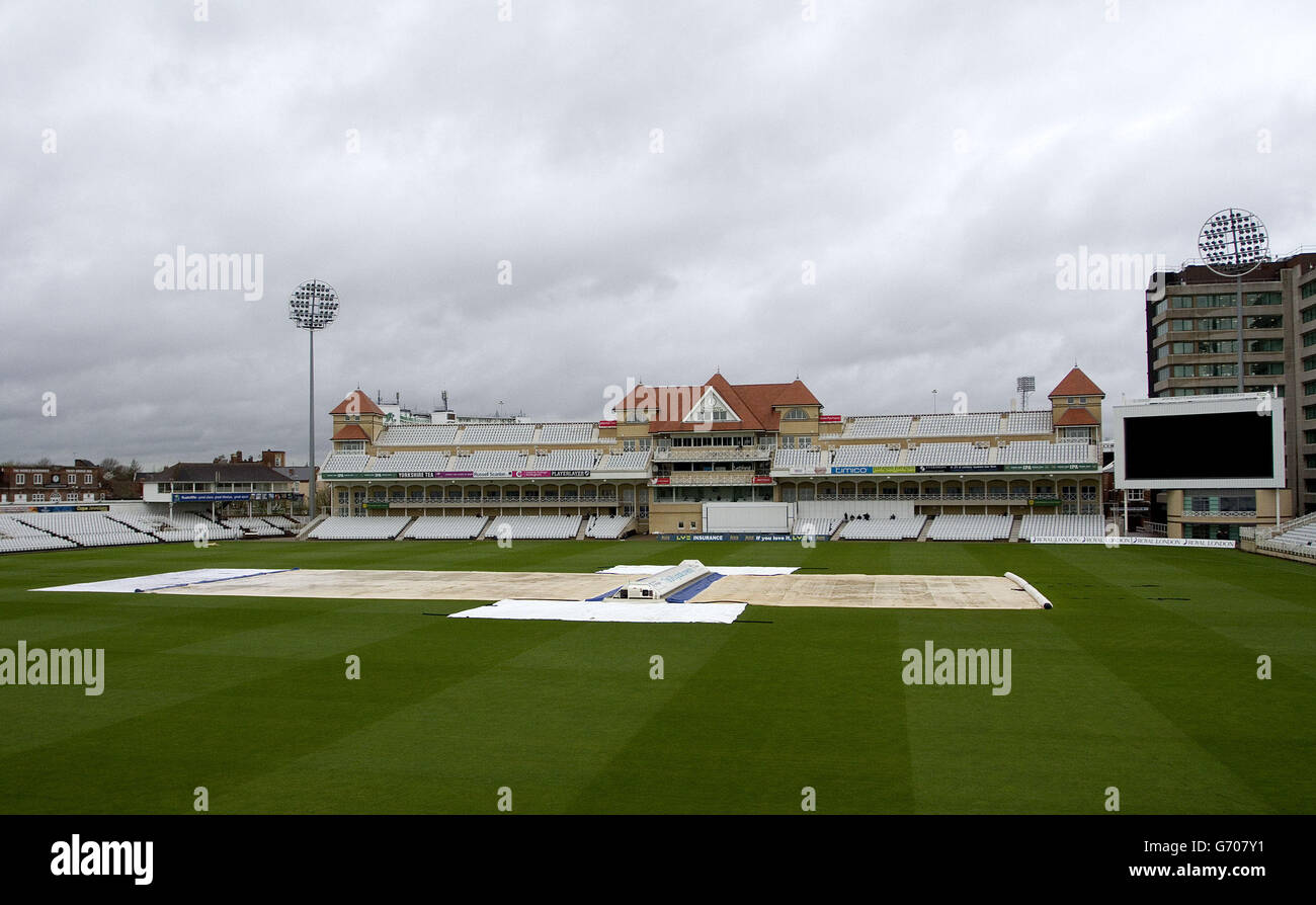The ground covers are kept on as rain delays the start of play during the LV=County Championship, Division One match at Trent Bridge, Nottingham. Stock Photo