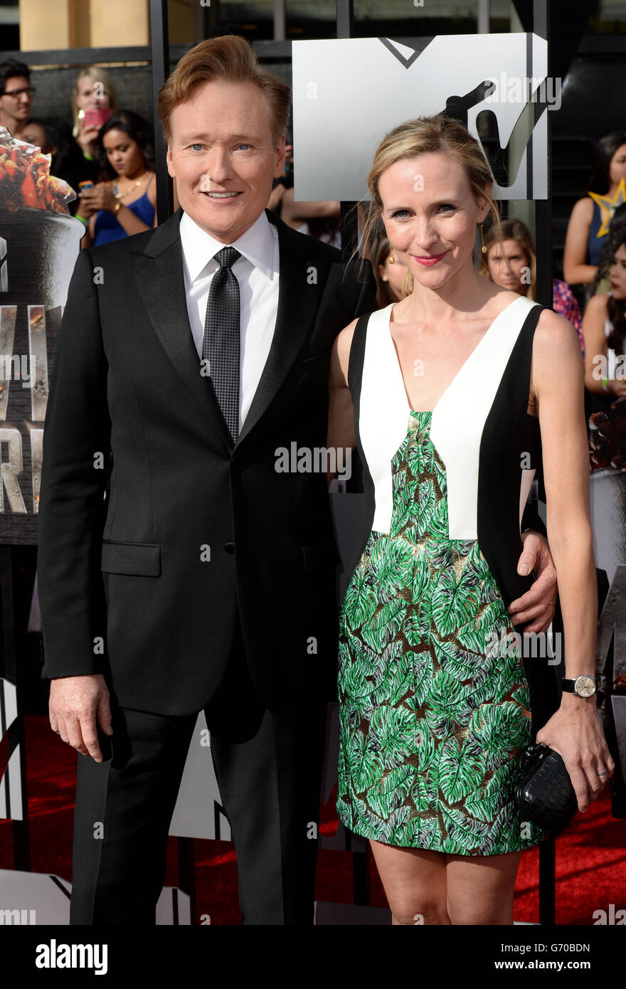 Liza Powel and Conan O'Brien arriving at The MTV Movie Awards 2014, at the Nokia Theatre L.A. Live, Los Angeles. Stock Photo