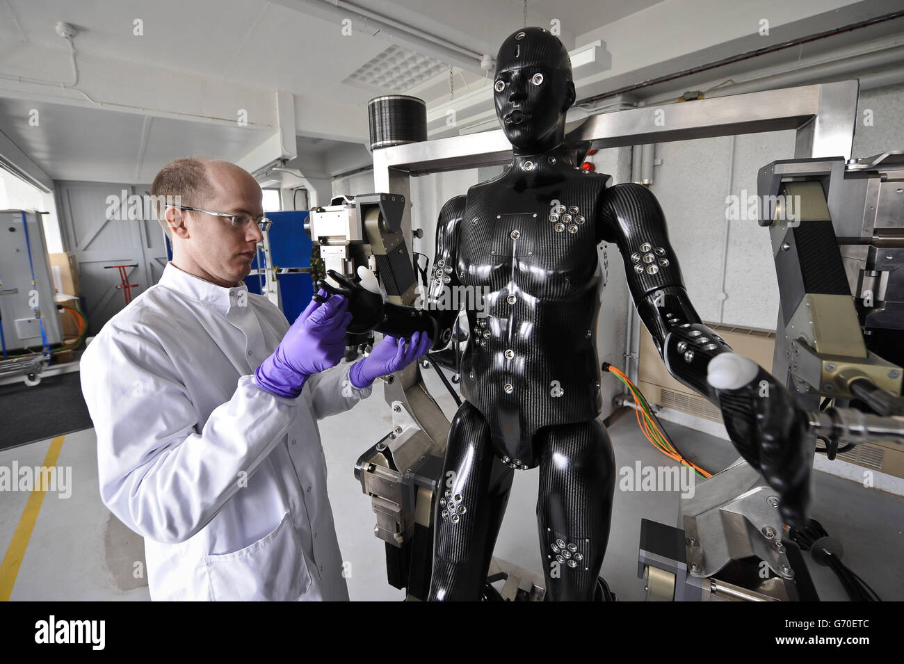 Jaime Cummins, of Dstl's Chemical and Biological Physical Protection group, checks the Porton Man robot mannequin, that will help test the next generation of chemical and biological suits for the UK's armed forces, which has been unveiled at Porton Down, Wiltshire. Stock Photo
