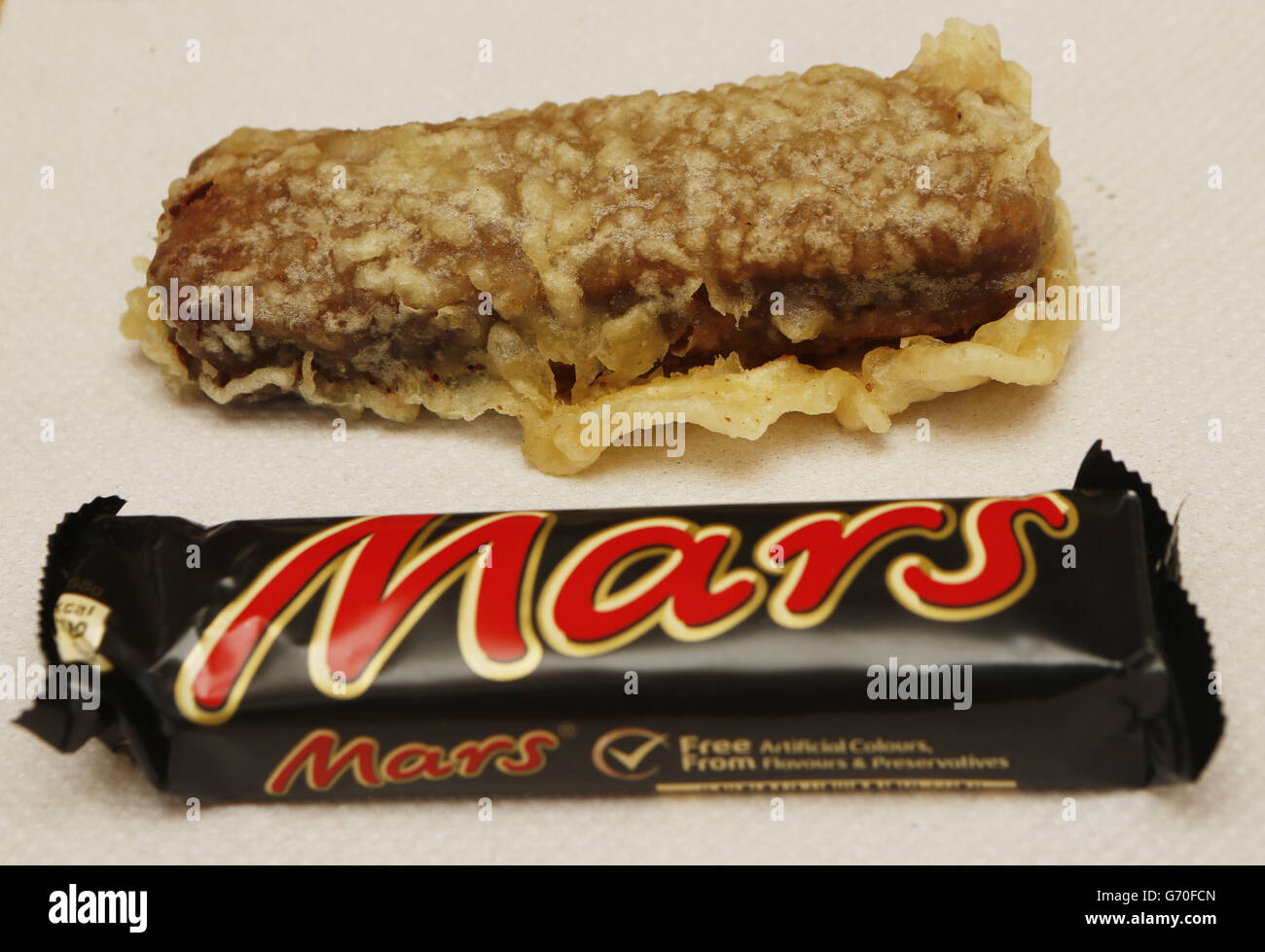 A deep fried Mars bar is prepared in a Glasgow chip shop ahead of the