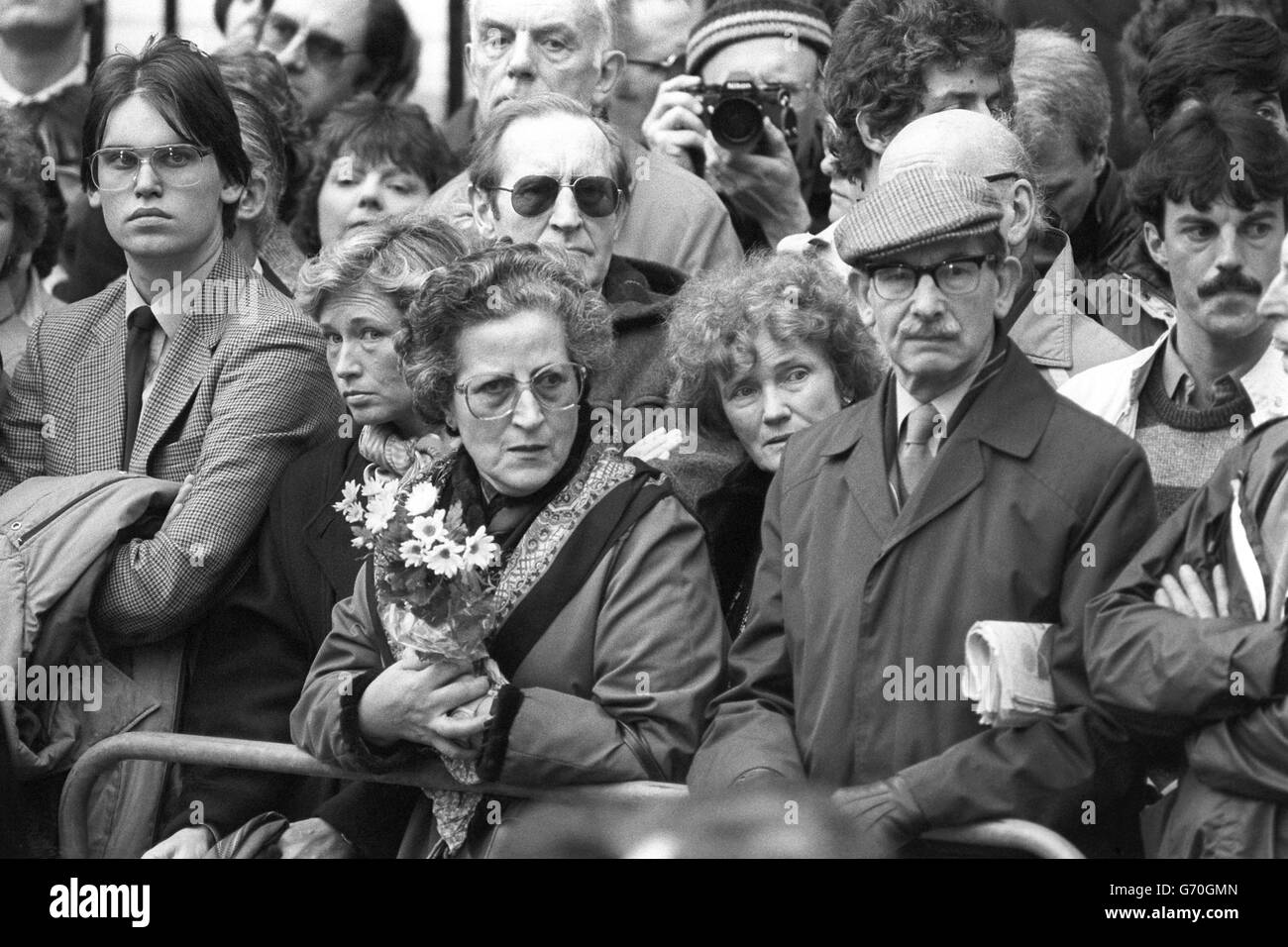 Flowers in the crowd in St James's Square, London, for the unveiling of a memorial to murdered policewoman Yvonne Fletcher near to where she was shot last April. Stock Photo