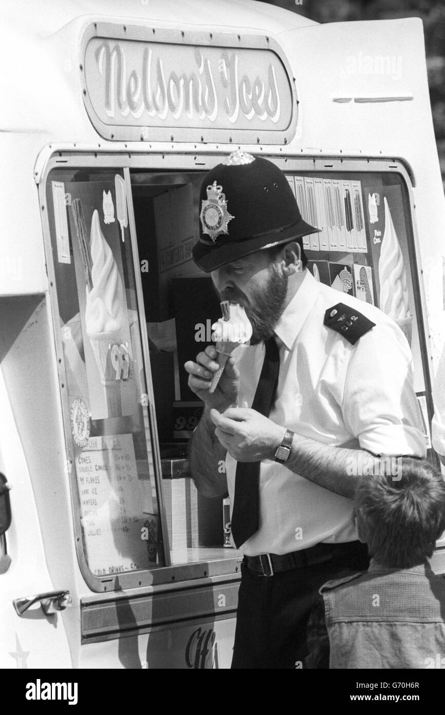 A policeman buys an ice cream to try to beat the heat in London while on a shift change at St James's Square in London, where the Libyan People's Bureau remains under siege. Stock Photo