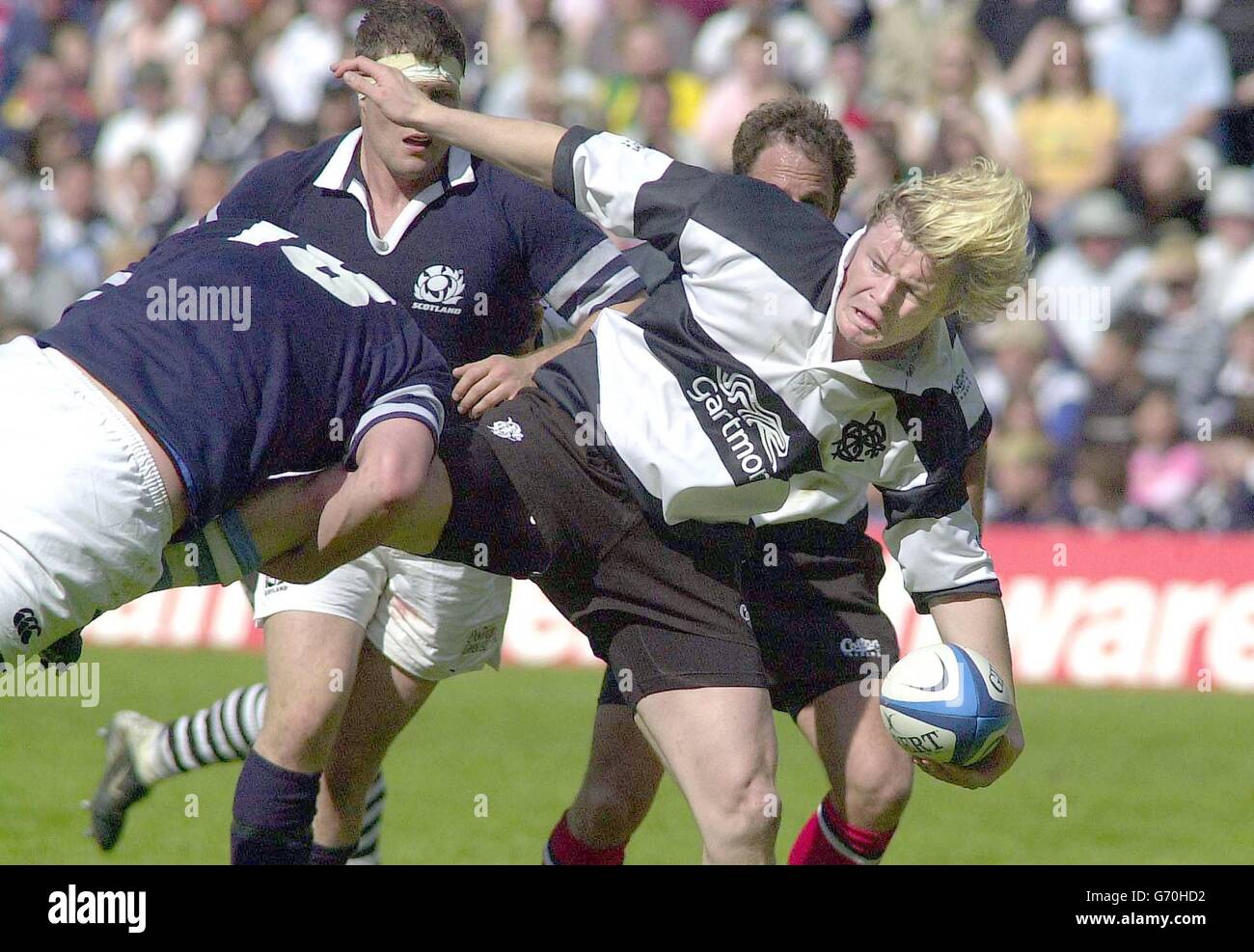 Barbarians' Brian O'Driscal with ball tackeled by Scotland's Scott Macleod, during their international friendly match at Murrayfield, Edinburgh Saturday May 22 2004. Stock Photo