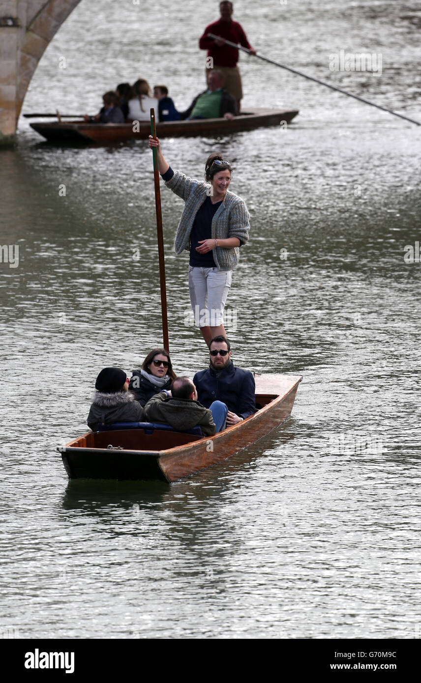 Tourist wrap up as they punt along the river Cam in the centre of Cambridge on Good Friday. Stock Photo