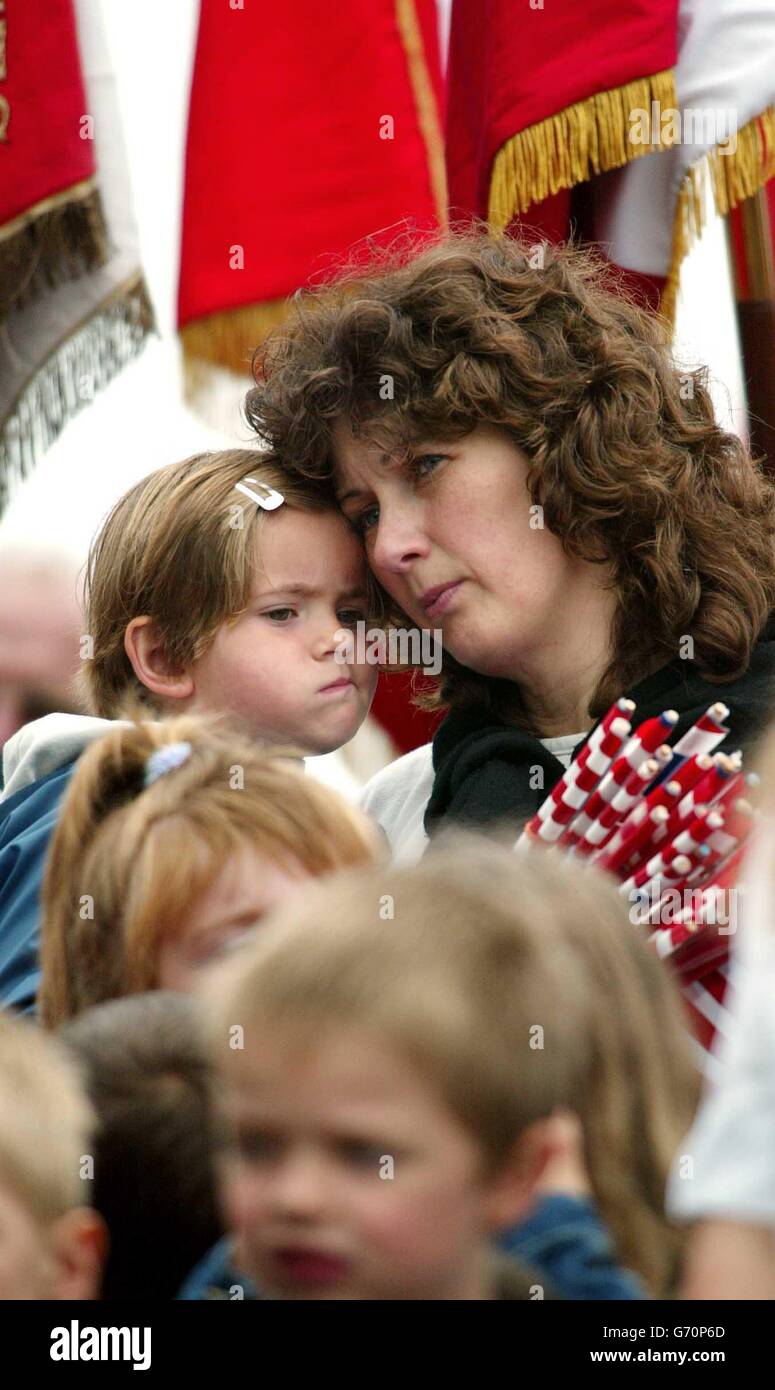 A French woman and her daughter from Magneville in Normandy at a memorial in their village to soldiers of the American 101st Airborne Division who were shot down on D-Day 1944. This weekend see events to mark the 60th anniversary of the allied invasion of Europe. Stock Photo