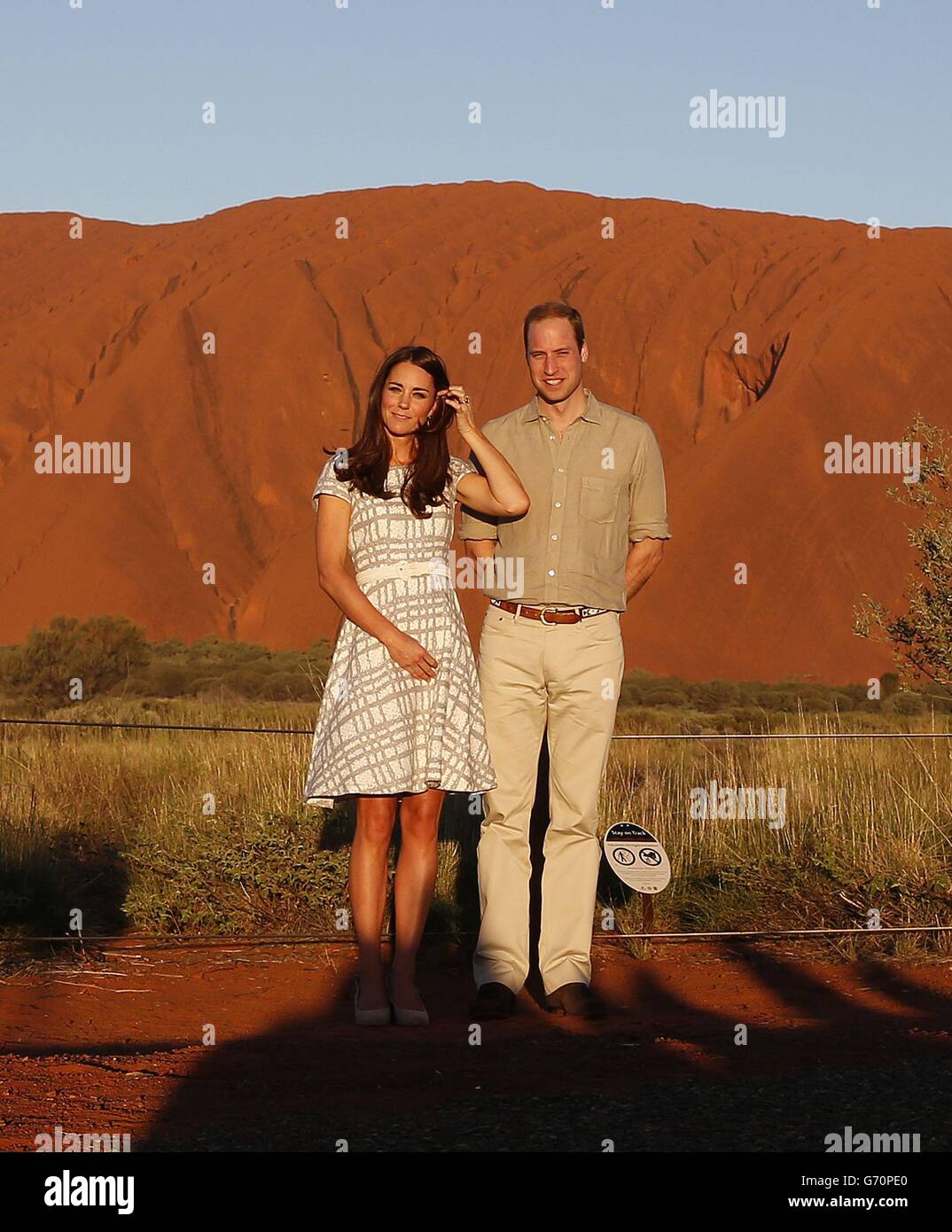 The Duke and Duchess of Cambridge pose for media with Uluru in the background during the sixteenth day of their official tour to New Zealand and Australia. Stock Photo