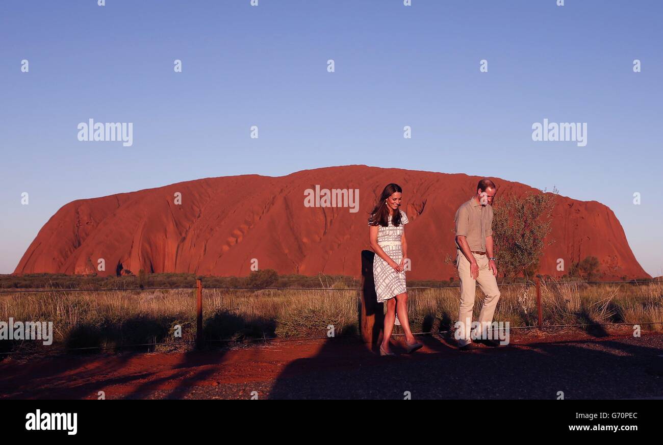 The Duke and Duchess of Cambridge pose for media with Uluru in the background during the sixteenth day of their official tour to New Zealand and Australia. Stock Photo